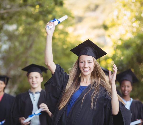 Graduate school kids standing with degree scroll in campus