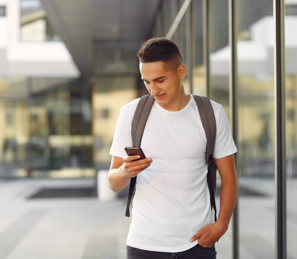 Student in a university campus with a phone