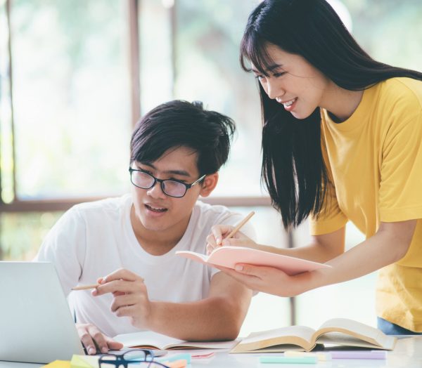 Young students campus helps friend catching up and learning.