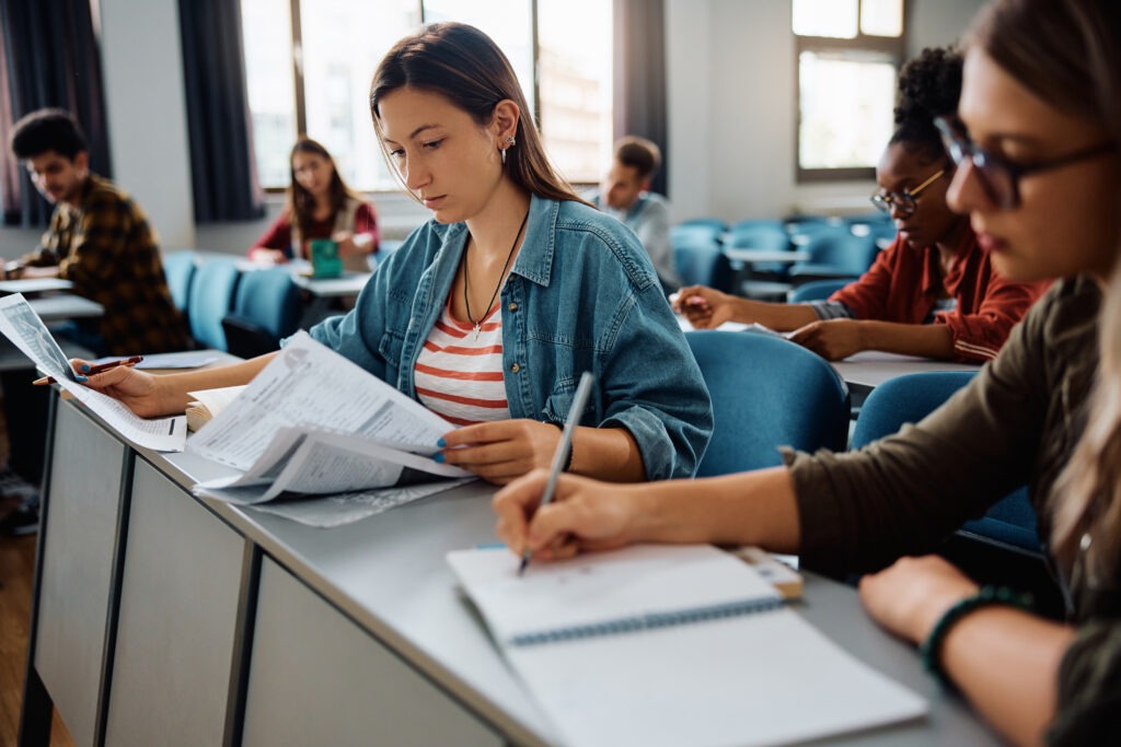 Female student learning during a class at university classroom.