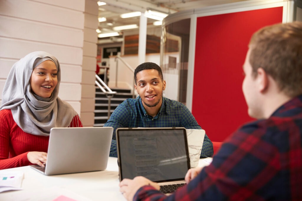 Group Of University Students Collaborating On Project