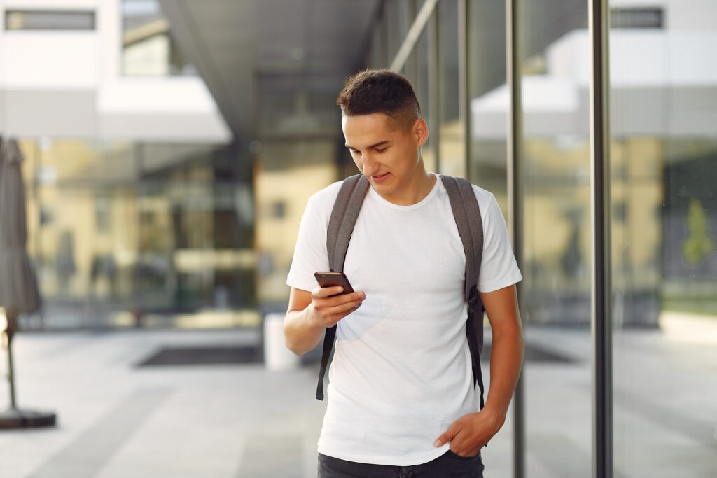 Student in a university campus with a phone