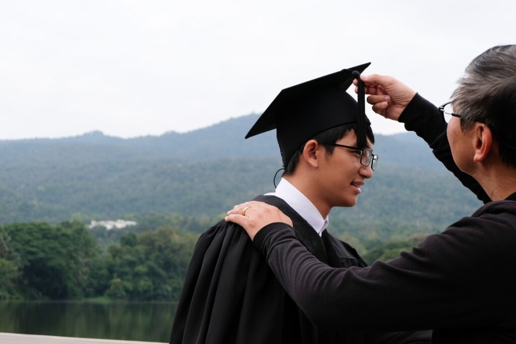 Student with congratulations, graduates wearing a graduation gown of university