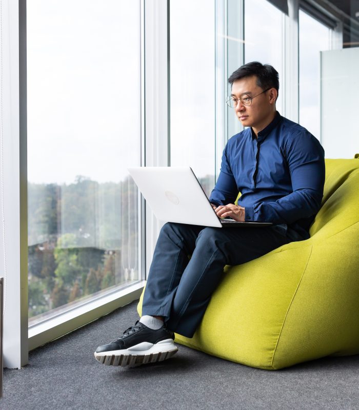 Serious and focused engineer developer programmer writing code using laptop at work to create Serious and focused engineer developer programmer writing code using laptop at work to create