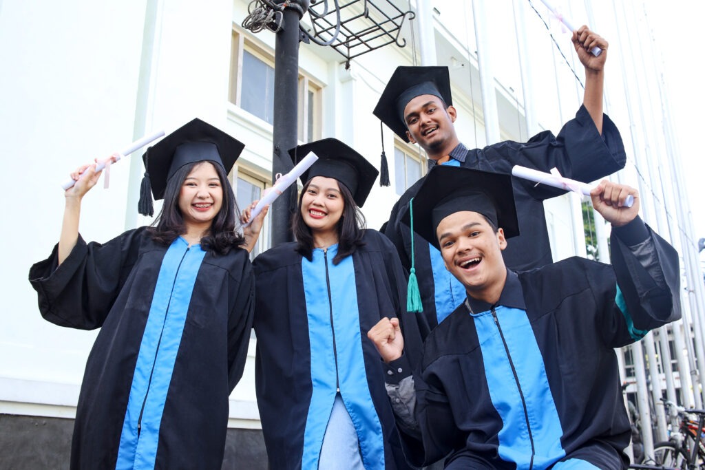 Group of graduated students celebrate their diploma and academic degree