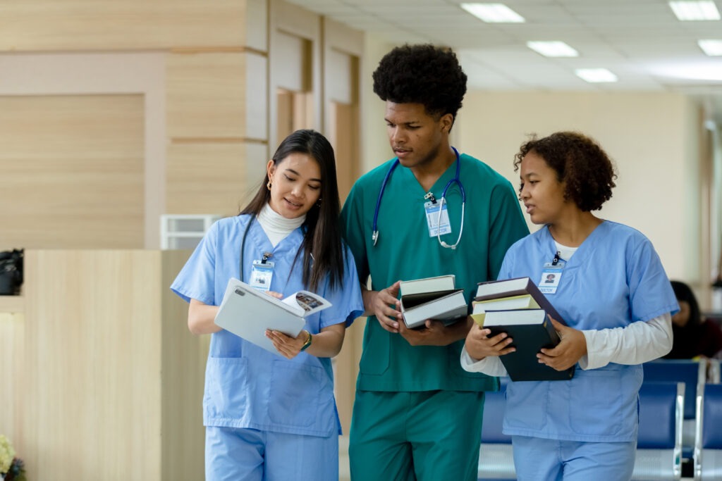 group of medical student holding book walking and talking in university.