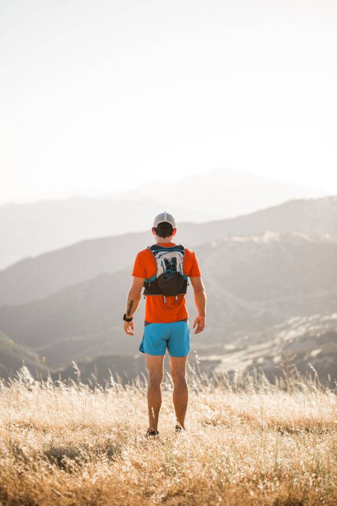 Man standing in rural setting, looking at view, rear view, Santa Barbara, California, USA
