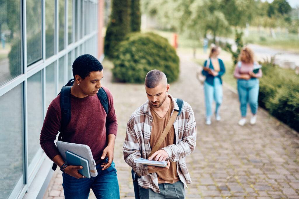 Young college friends going to lecture at the university.