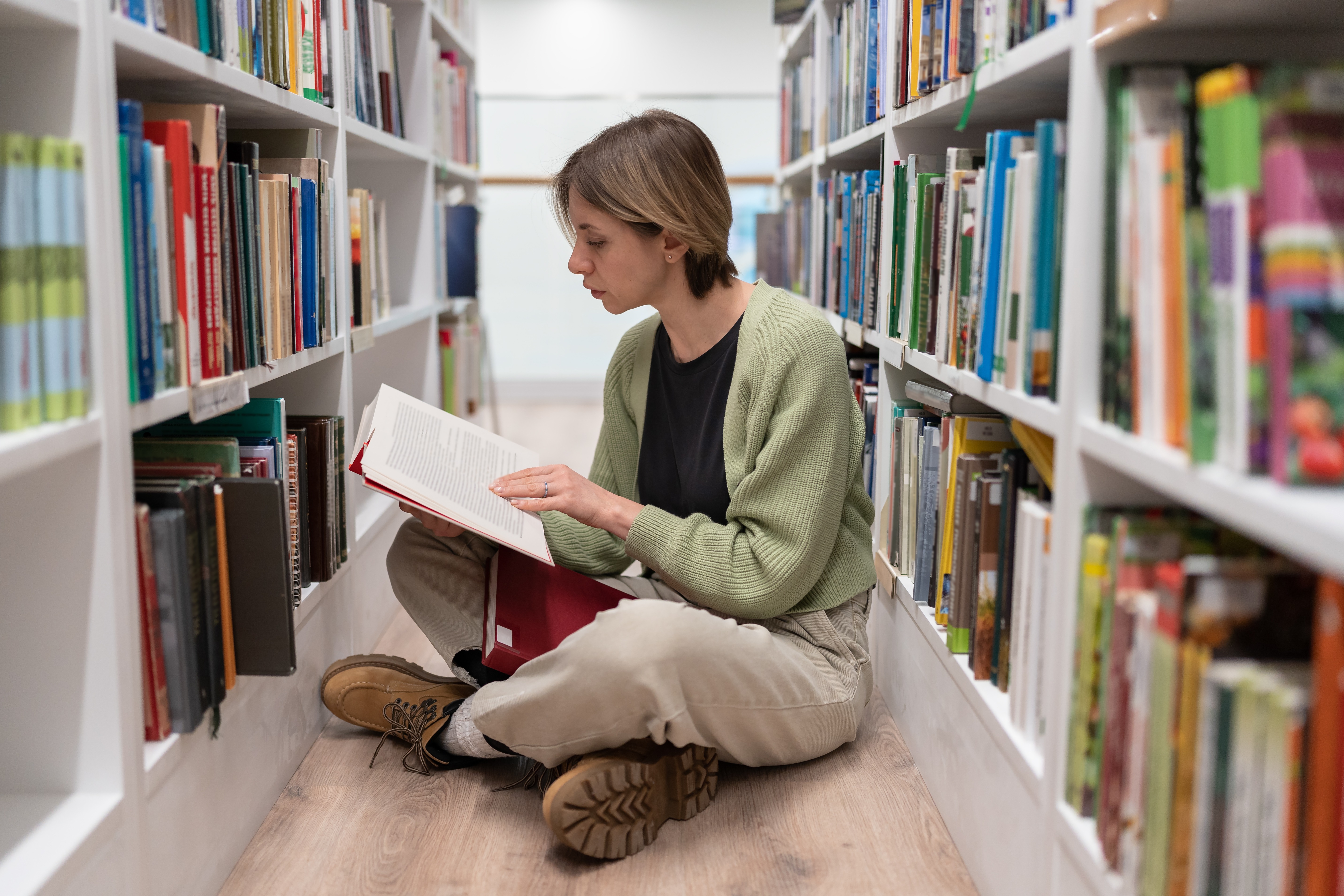 Focused attractive woman chief editor at major publishing house working on best-seller famous author