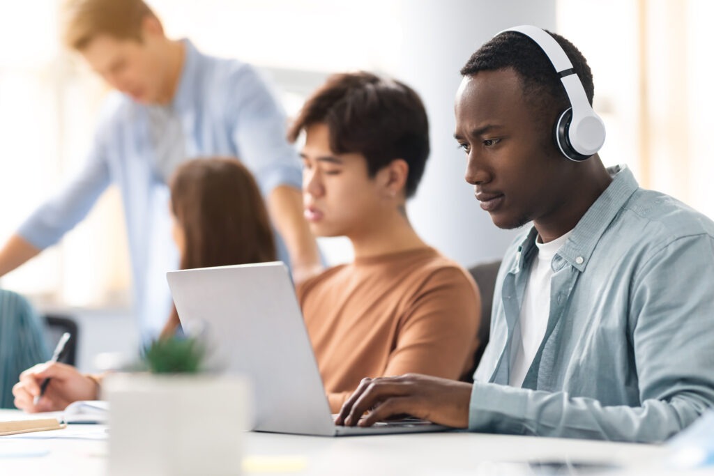 Group of international people using laptops in classroom