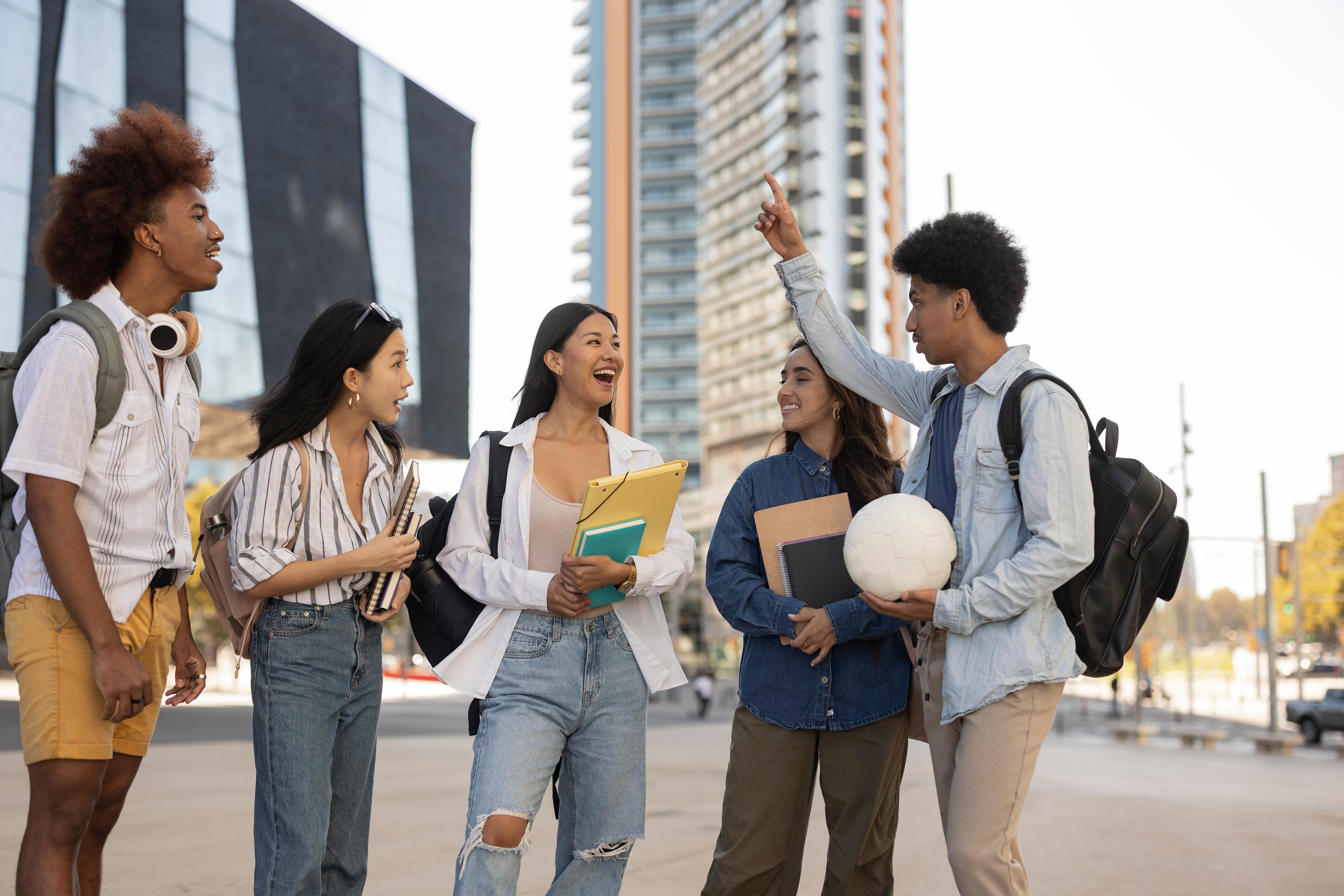 multiracial group of college students walking out of college